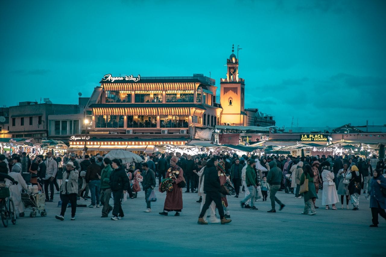 Gnawa music in Morocco — where to hear it and what a lila is Crowds fill Jemaa el-Fnaa square in Marrakech at dusk beside lit food stalls